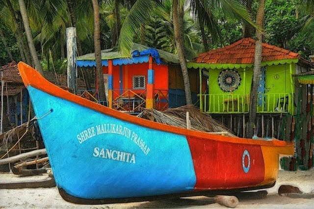 Colorful boat and houses on a beach